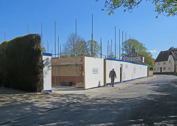 Builder and homeowner reviewing a written quote on site